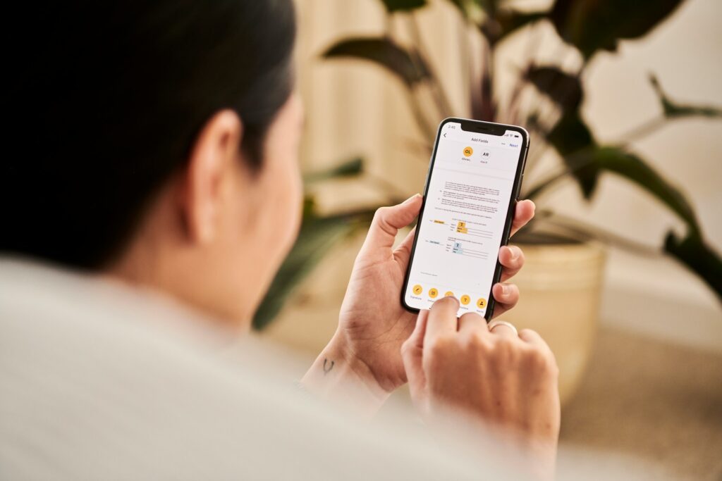 A woman looking at a contract on DocuSign from a iPhone